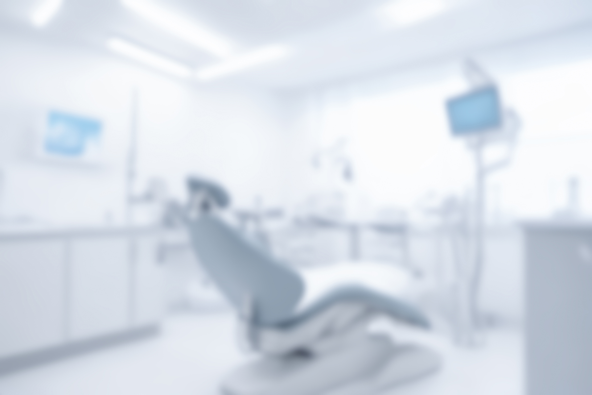 Blurred dentist office interior with empty chair, dental instruments, modern clinic room, professional healthcare setting, oral care equipment